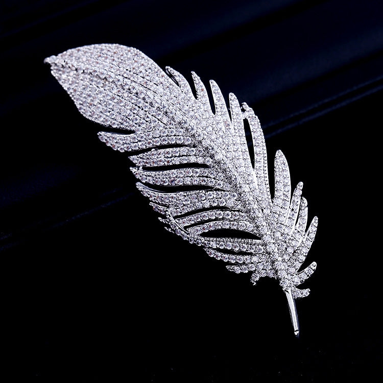 Silver-tone feather brooch with layered crystal sparkle