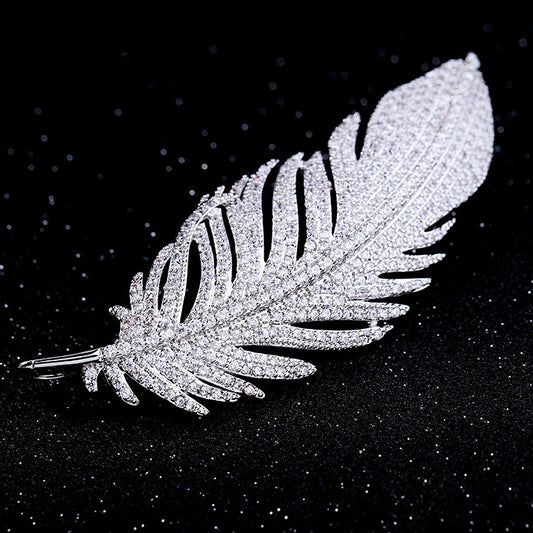 Jeweled feather brooch with sparkly texture and pin stem