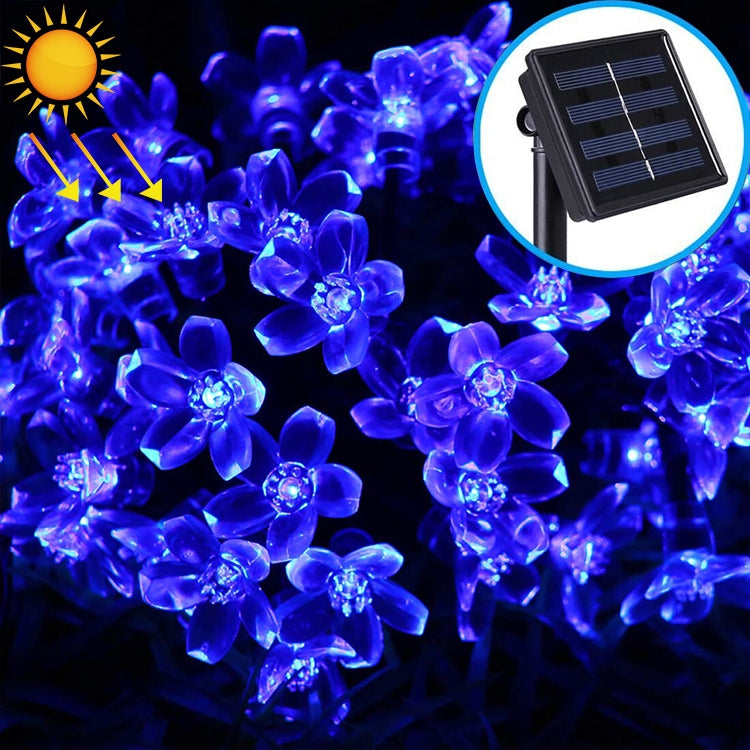Blue glowing solar flower LED light string with translucent flower bulbs and solar panel inset