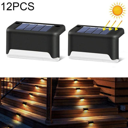 Solar powered outdoor stair lights, black plastic with built-in solar panels and warm glow.