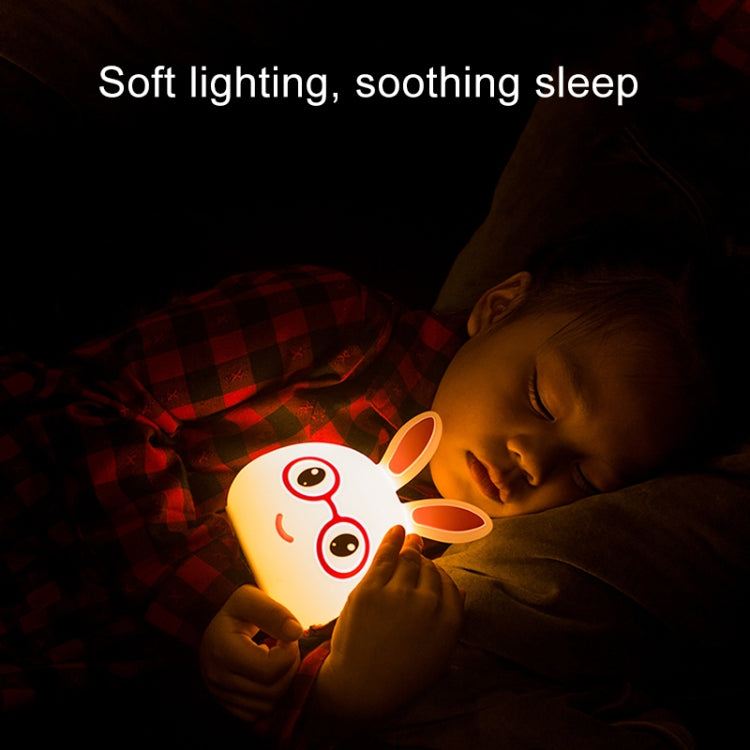 Battery LED rabbit night lamp with glowing face beside a sleeping child