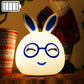 Battery LED rabbit night lamp with blue glowing closed eyes and smiling glasses face