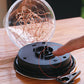 Solar pendant lamp base with black circular controls and clear top dome showing copper wire strands