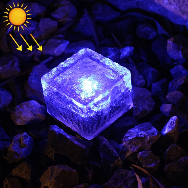 Solar LED buried light cube with blue glow through clear textured glass