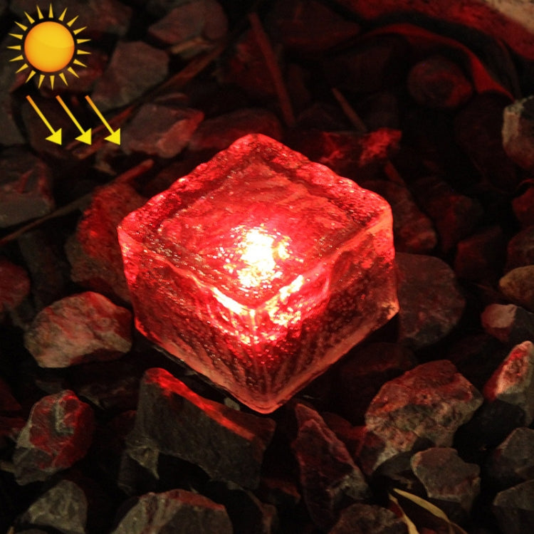 Solar LED buried light cube with red glow through clear textured glass