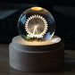 Glowing crystal ball music box night light on round wooden base with circular light motif.
