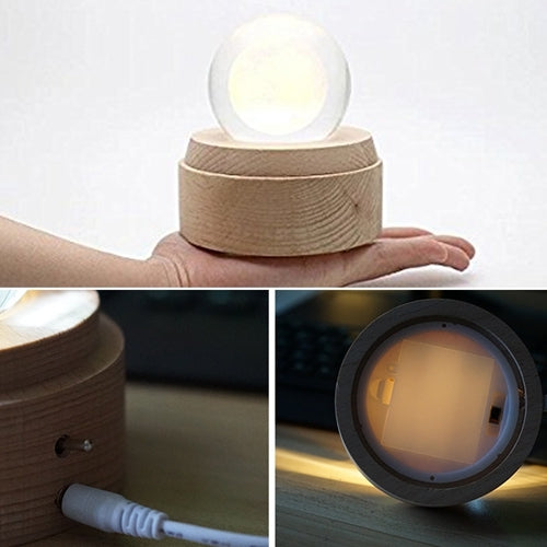 Crystal ball music box night light with glowing top and side power port on wooden base.