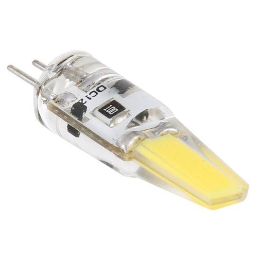 Clear LED corn light bulb showing circuit boards and warm yellow LED, two metal pins