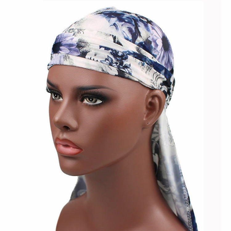 Long-tailed pirate hat headscarf with blue floral print, wide band and tied back