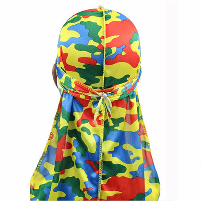 Camouflage pirate turban cap with long drape, red/blue/green pattern and tie detail