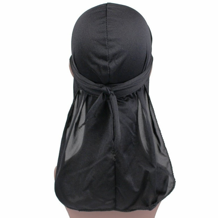 Black long-tailed headscarf hat with gathered fabric and front tie detail