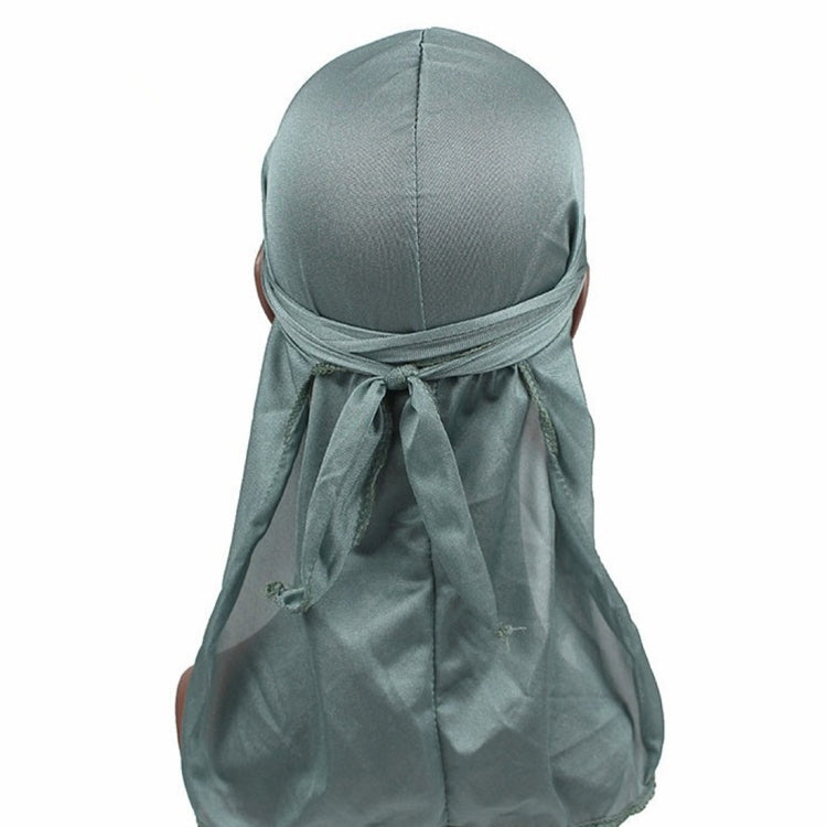 Sage green long-tailed headscarf hat with gathered fabric and tied back