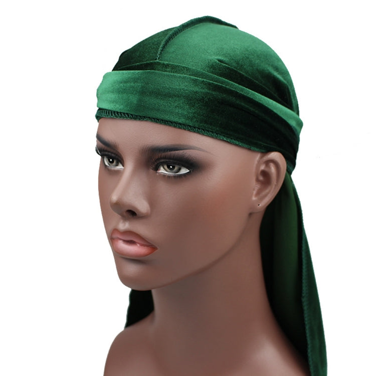 Green velvet turban cap with wide band and long trailing side tail