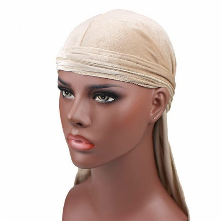 Beige velvet turban cap with horizontal wrap and long trailing tail