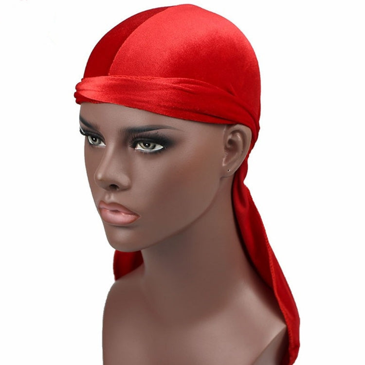 Red velvet turban cap with wrapped band and long trailing side tail