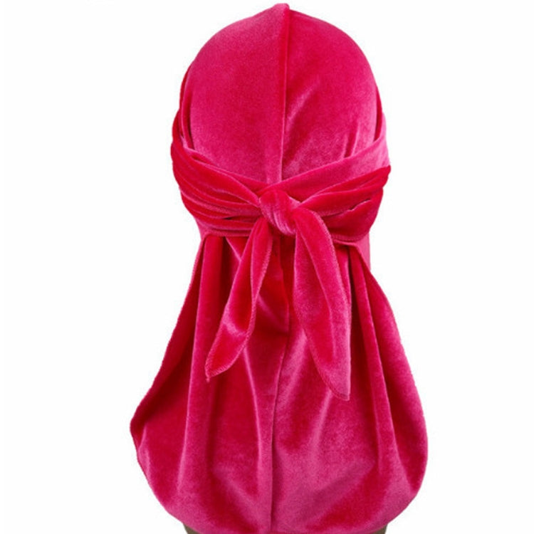 Hot pink velvet turban cap with gathered knot and long trailing tail
