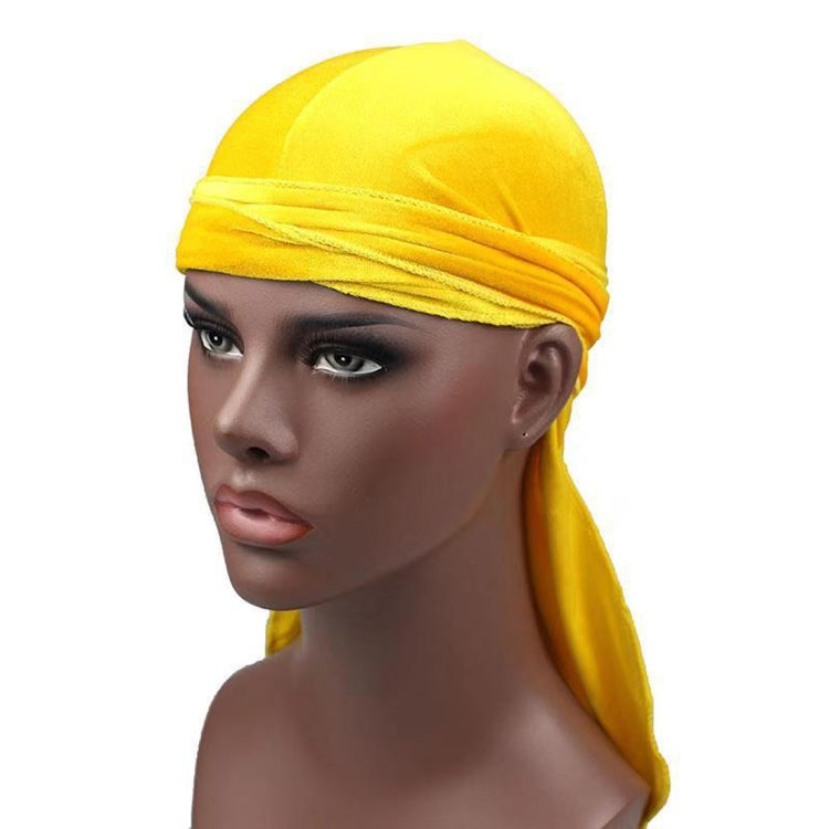 Bright yellow velvet turban cap with wrapped band and long trailing side tail