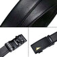 Men's black leather belt close-up of textured strap and automatic buckle hardware