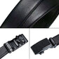 Black leather belt buckle and textured strap close-up detail