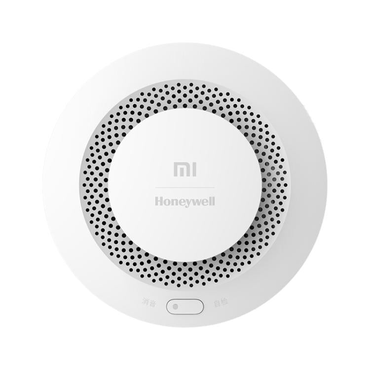 White circular smoke and fire alarm detector with perforated speaker ring and small button