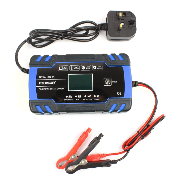 Blue and black battery charger with UK plug, display panel, and red/black clamps