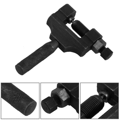 Black motorcycle chain breaker tool with textured handle and threaded screw