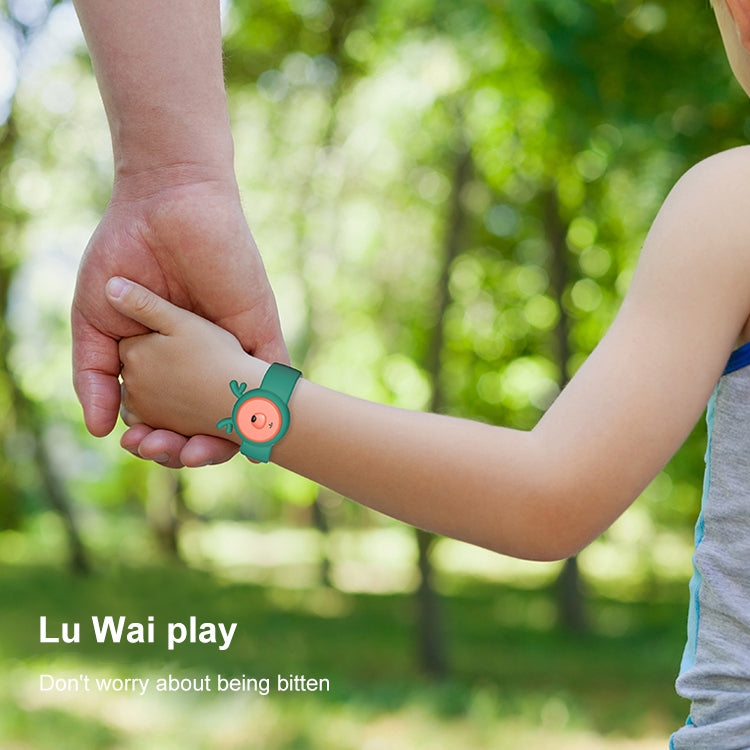 Green children’s mosquito repellent wristband on a child’s arm