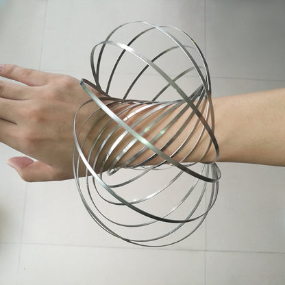 Stainless steel coiled fidget spinner spring bracelet with multiple metal loops, held in hands