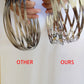 Stainless steel coiled fidget spinner spring bracelet loops held close to camera
