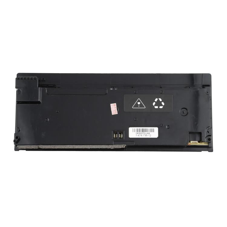 Game console power supply underside with warning icons and connector socket