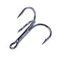 Set of black three-jaw treble fishing hooks with sharp barbed tips