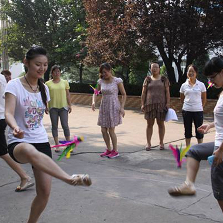 Kids practicing footwork with colorful feather shuttlecocks during play