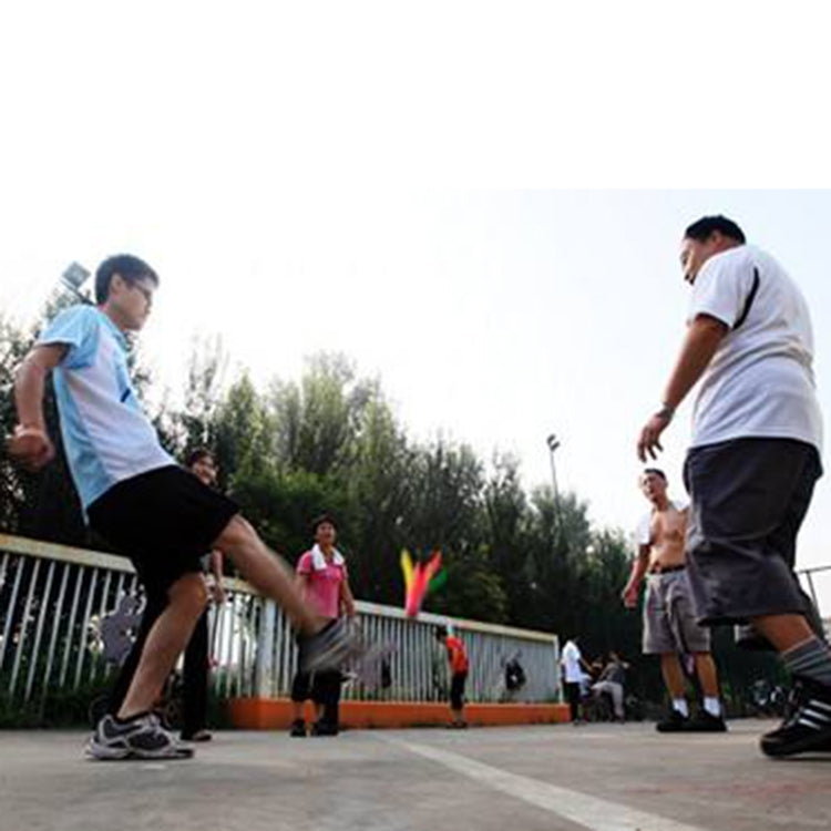 People playing foot exercise with colorful feather shuttlecocks outdoors