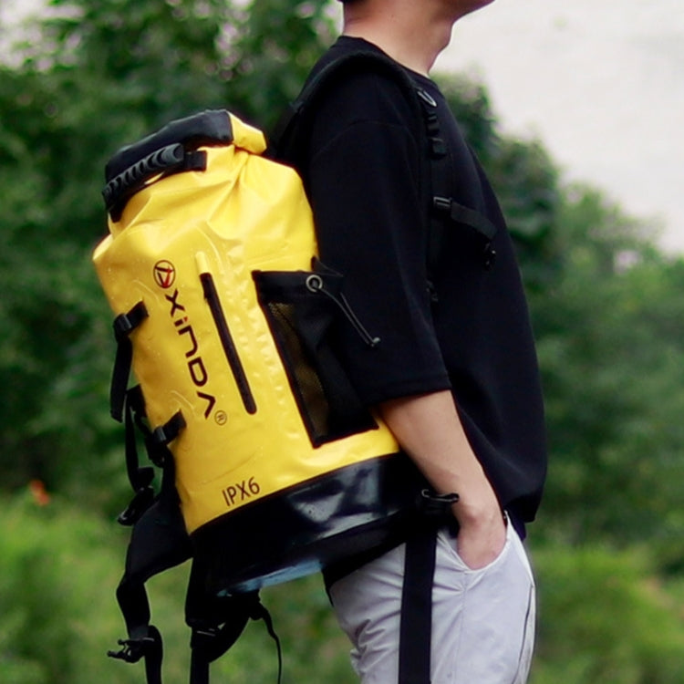 Yellow waterproof dry bag with shoulder straps, roll-top closure, and side buckles, 30L