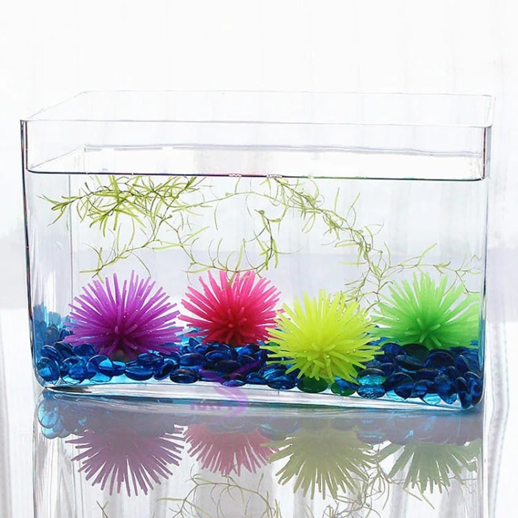 Set of colorful artificial sea urchin coral balls inside a clear aquarium tank