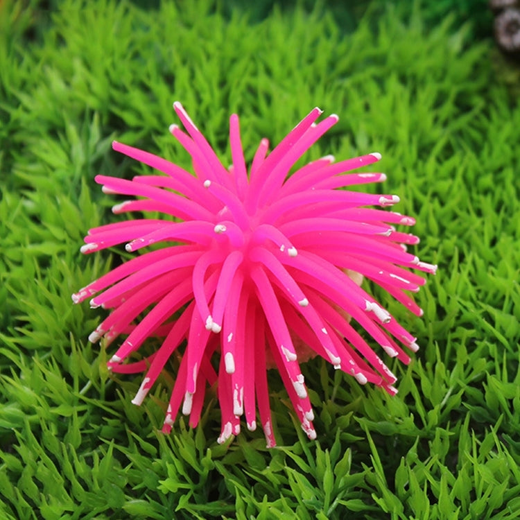 Pink spiky sea urchin ball coral decoration with pointy arms, aquarium ornament.