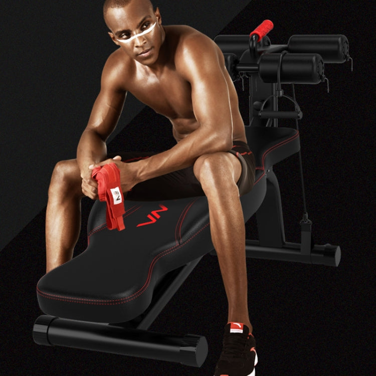 Black abdominal curl exercise bench used for weighted leg curls with red roller grips