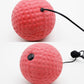 Red textured training boxing balls with black eyelets and connected pull cord