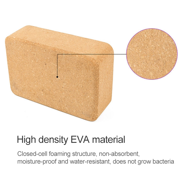 Cork yoga block end view, tan textured surface on rectangular support brick