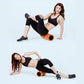 Orange high-density foam roller for core and leg stretching, held by person