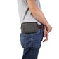 Dark gray waist phone bag worn at hip over blue jeans with zippered front