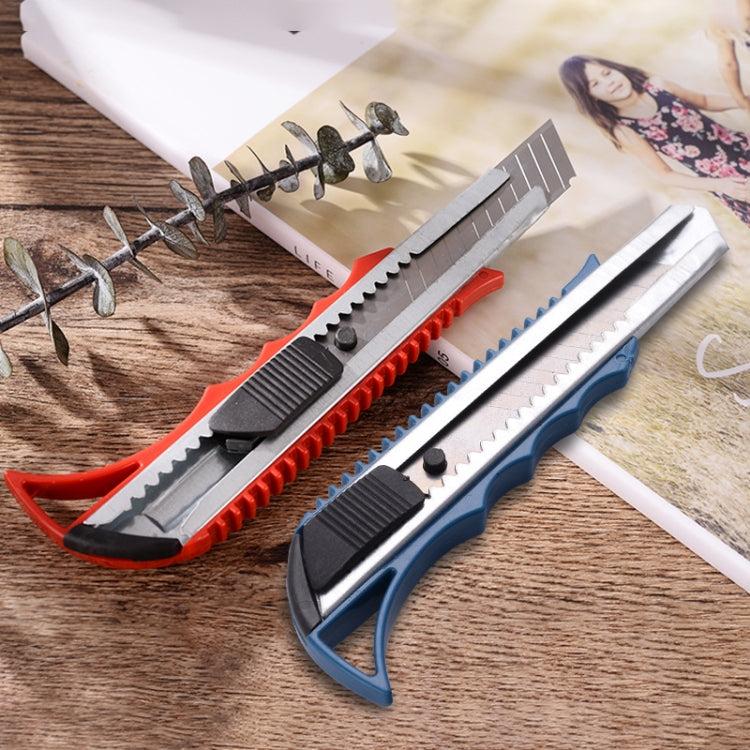 Utility paper cutter knives with red and blue handles on desk with stainless blades