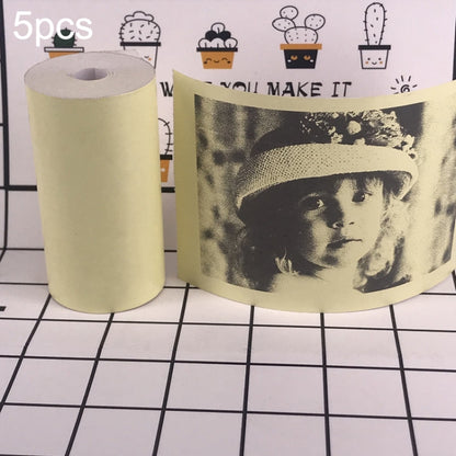 Cream thermal label paper roll with printed portrait-style sticker sheet