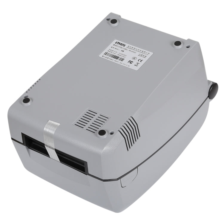 Grey thermal barcode printer bottom view with label, vents, and power ports
