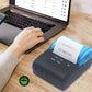 Thermal paper roll in a printer while a user operates a laptop keyboard