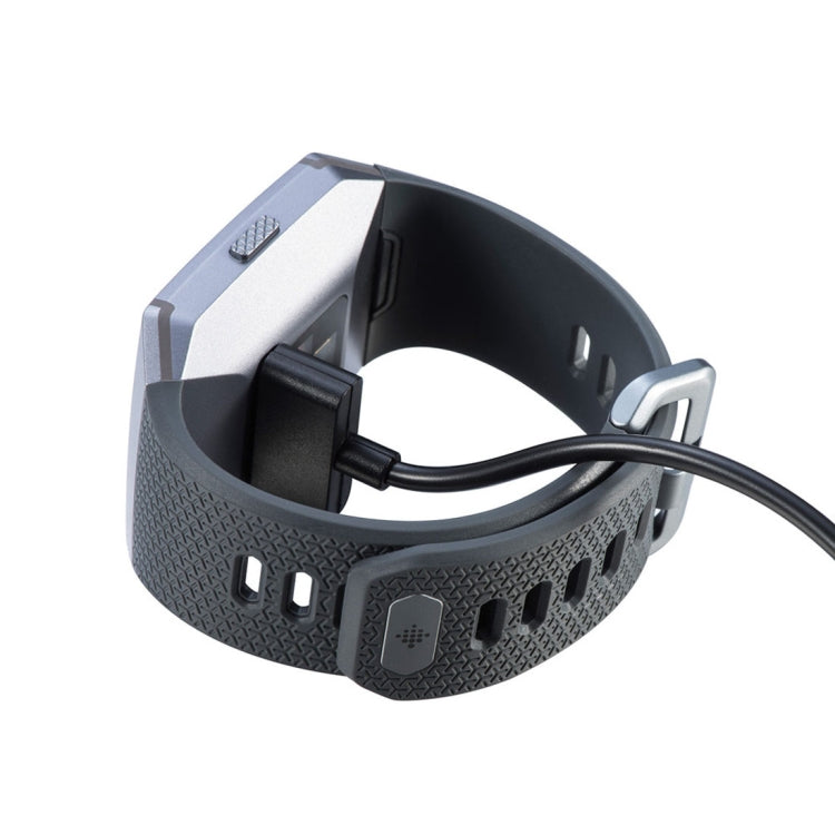 Smart watch charging clip dock with black cable and visible contact points