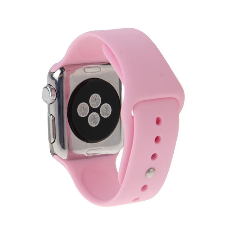 Pink rubber Apple Watch band with pin-and-tuck closure, watch case visible