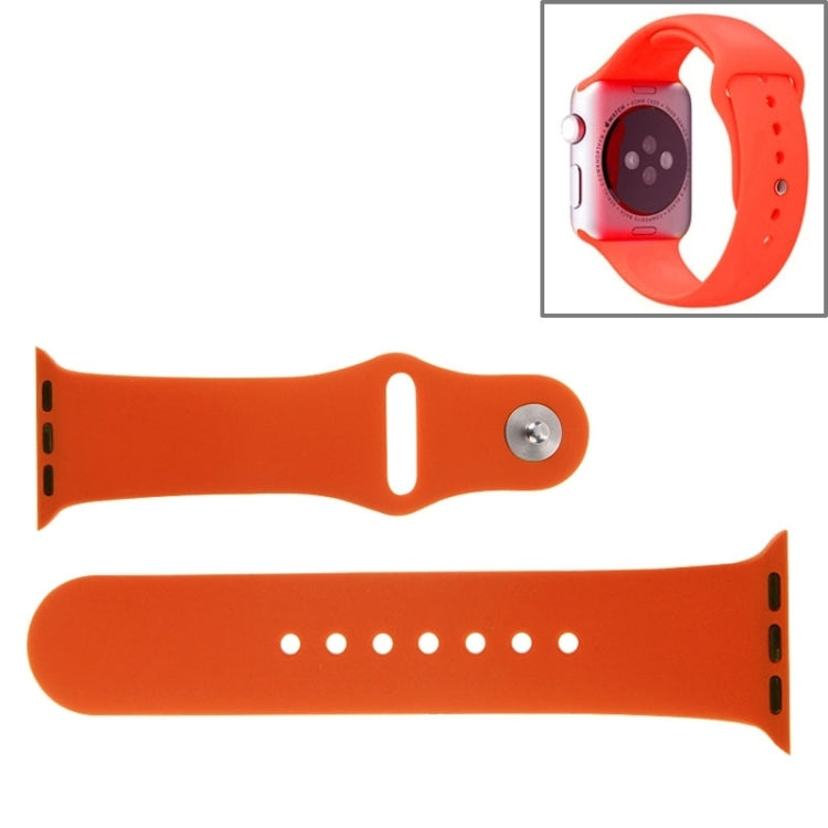 Orange rubber Apple Watch sport band with pin-and-tuck closure and adjustment holes