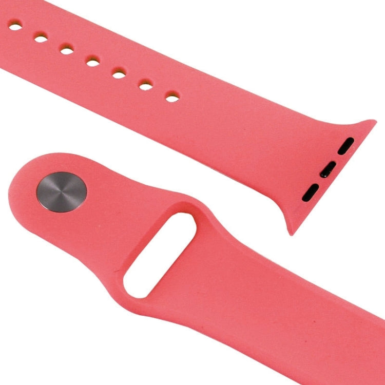 Pink rubber watch band detail with metal pin plate and ventilation hole pattern