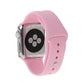 Pink rubber sport watch band with pin-and-tuck closure shown on Apple Watch